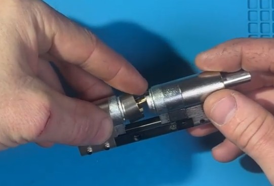 Мужчина мастер пытается собрать модульный цилиндр